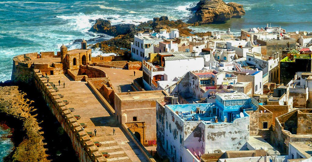Essaouira beach view from the medina" "Goats climbing Argan trees in Morocco" "Seaside lunch in Essaouira" "Historic ramparts of Essaouira Kasbah" "Traditional Moroccan art in Essaouira"