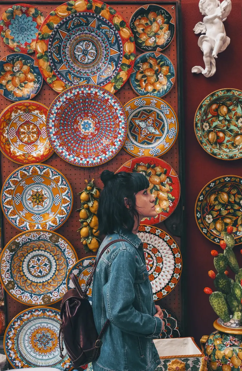woman-wearing-blue-denim-jacket-across-plates-morocco-souk-moroccotravelbliss Shopping & Moroccan Handicrafts – Treasures of Morocco